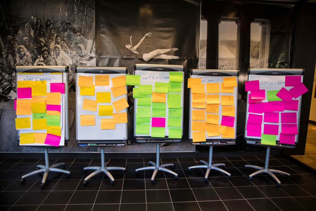 Large notepad stands with colored stickies on them