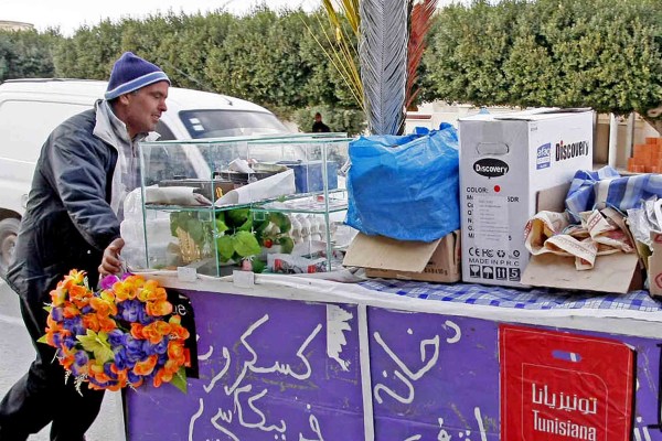 A street vendor walks with his cart in the town center of Sidi Bouzid. Credit: KHALIL/AFP