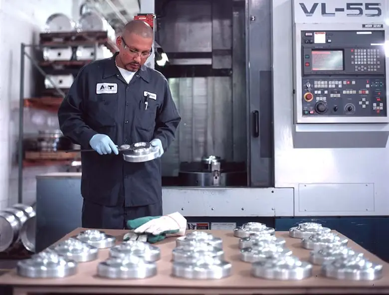 An individual inspects equipment while at a manufacturing facility.