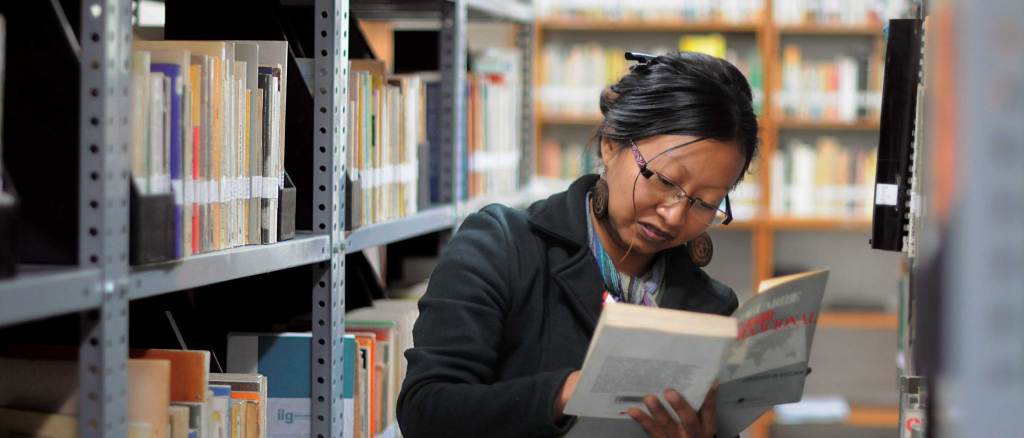 Woman researching in a University library.