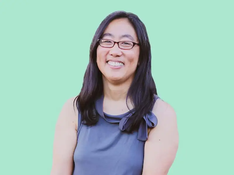 Image of Stacy Kono wearing a blue top against a light green background.