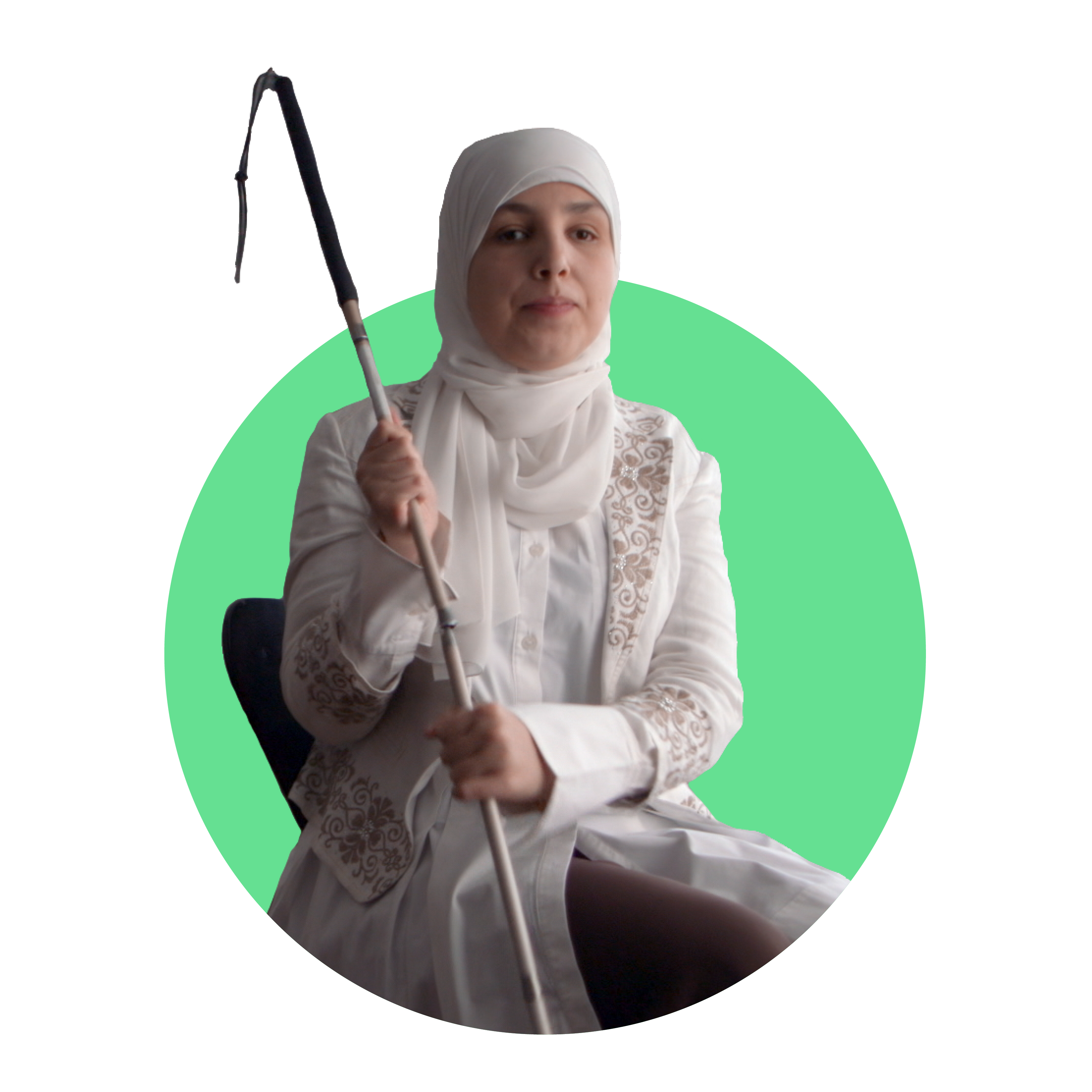 Sara Minkara, a blind Lebanese-American woman, wearing a white headscarf holds her cane with both hands to her right while seated.